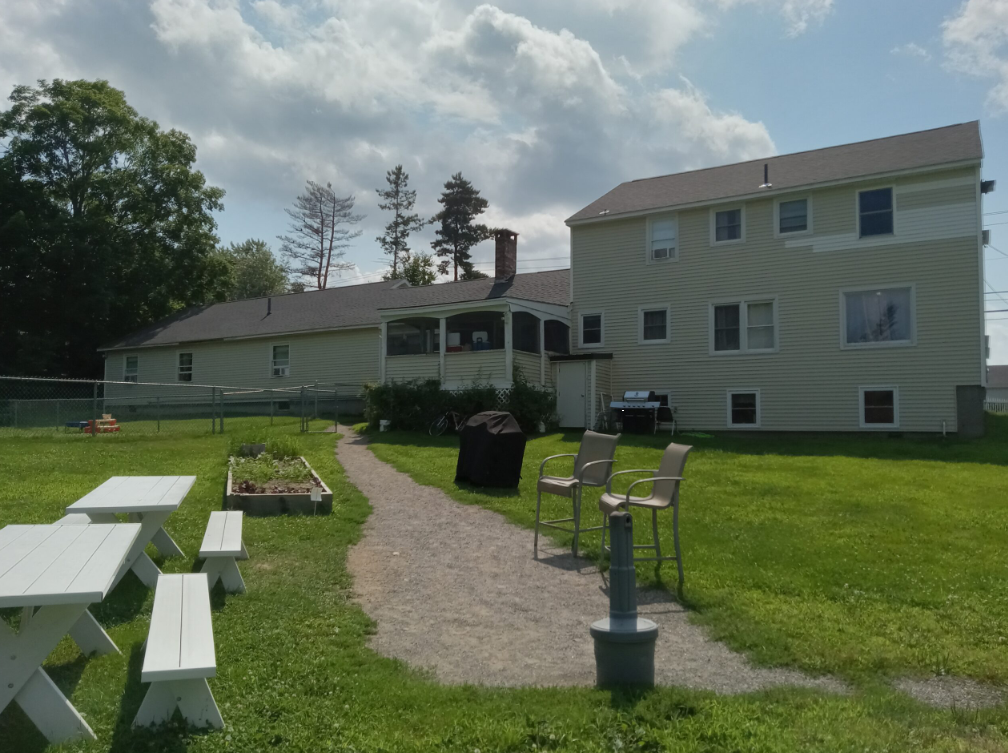 Spacious backyard with picnic tables and grill