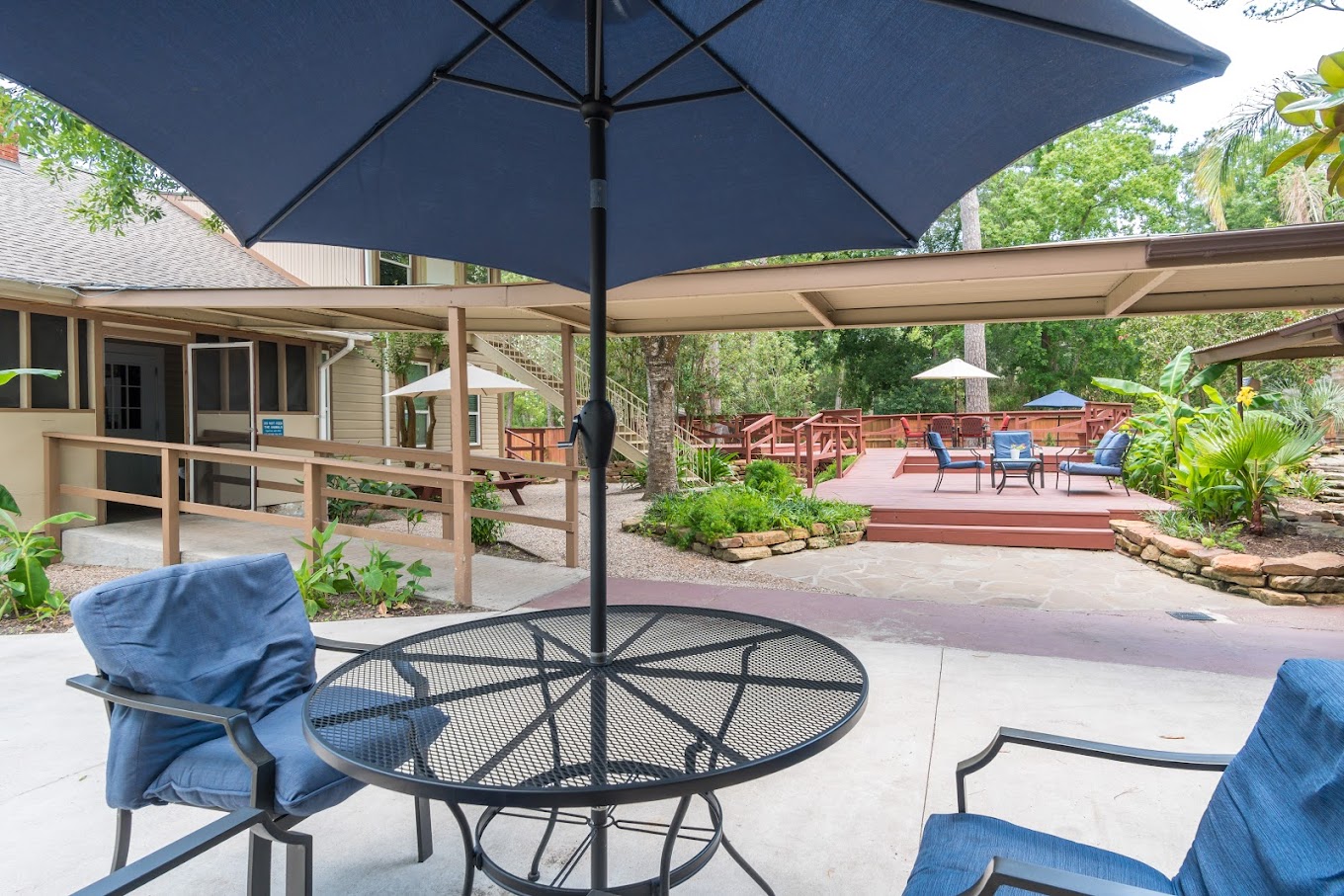 Patio area with seating under large umbrellas.