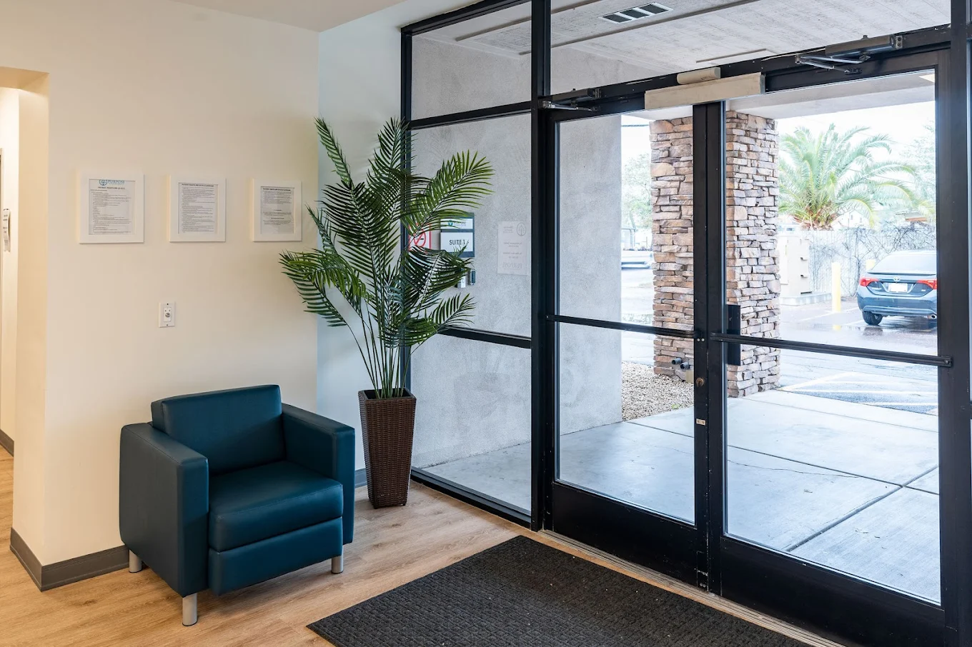 Lobby entrance with glass doors and seating area