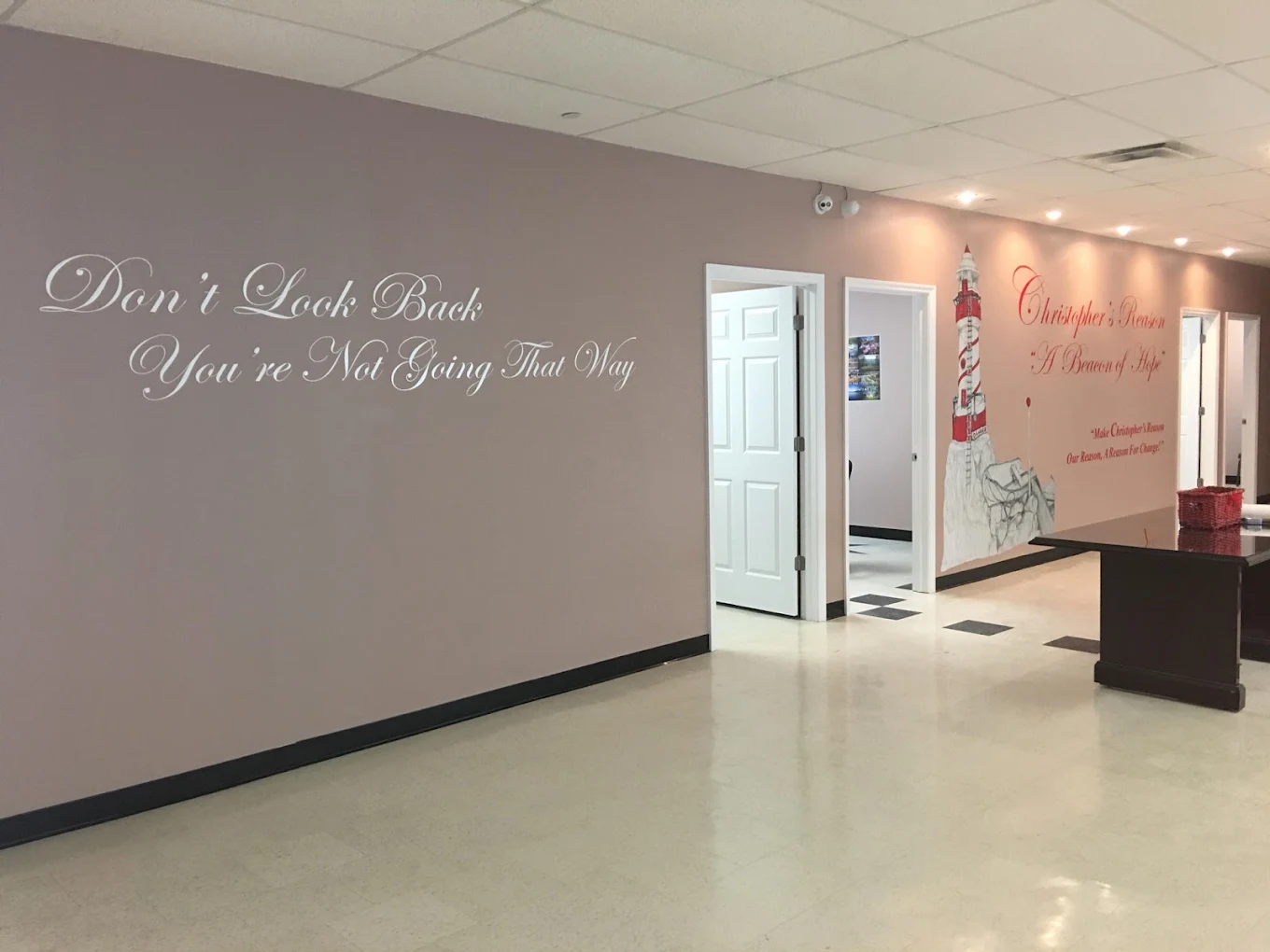 Hallway with quote on wall and open office doors
