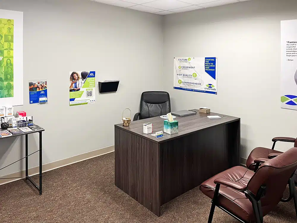 Private consultation office with desk, chair, and pamphlets