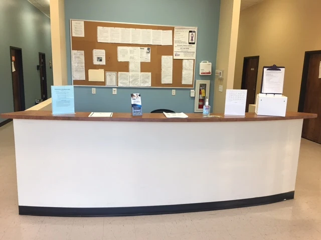 Front desk with bulletin board in reception area