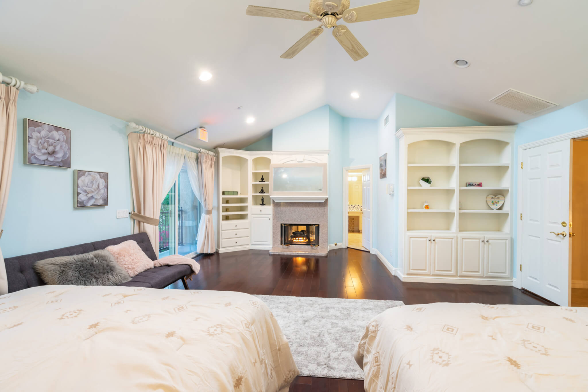 Shared bedroom with two twin beds and fireplace seating nook