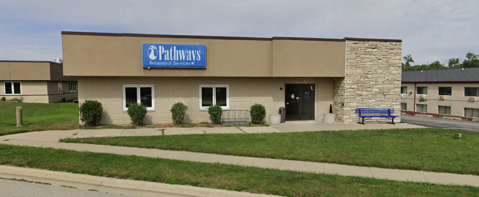Rehab facility front with blue sign and modern brick exterior