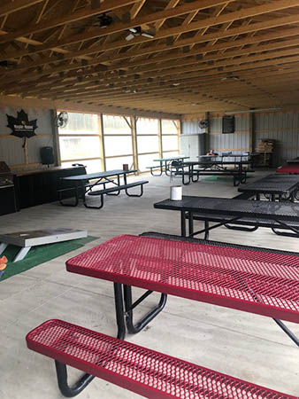 Covered pavilion with picnic tables and recreational space.
