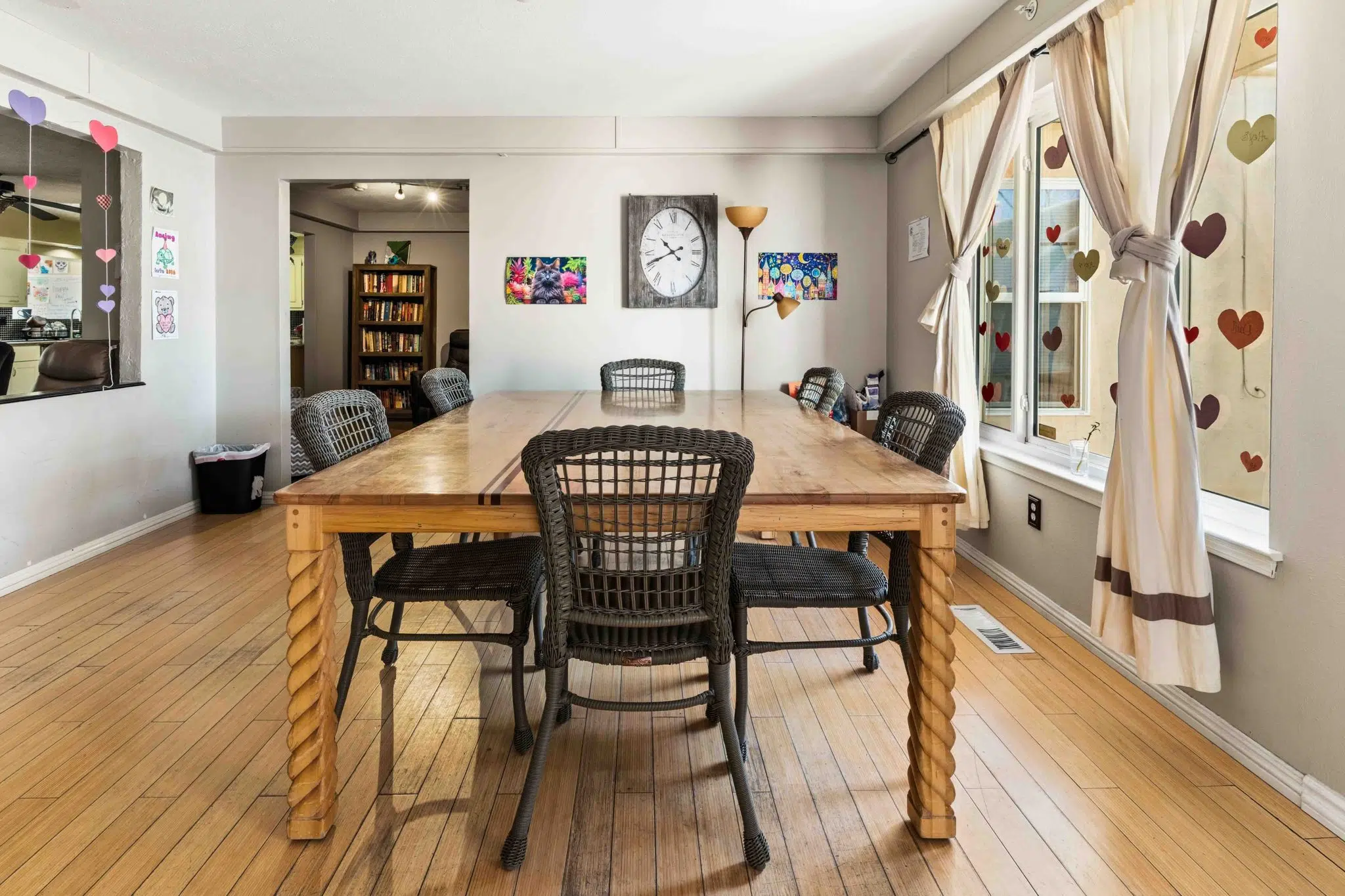 Shared dining room with large wooden table and seating