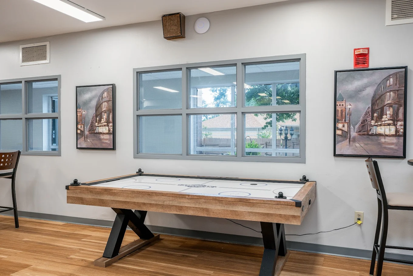 Air hockey table in recreation space with wall art