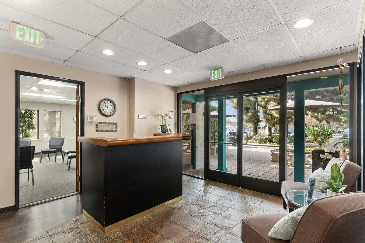 Reception area with front desk and facility entrance