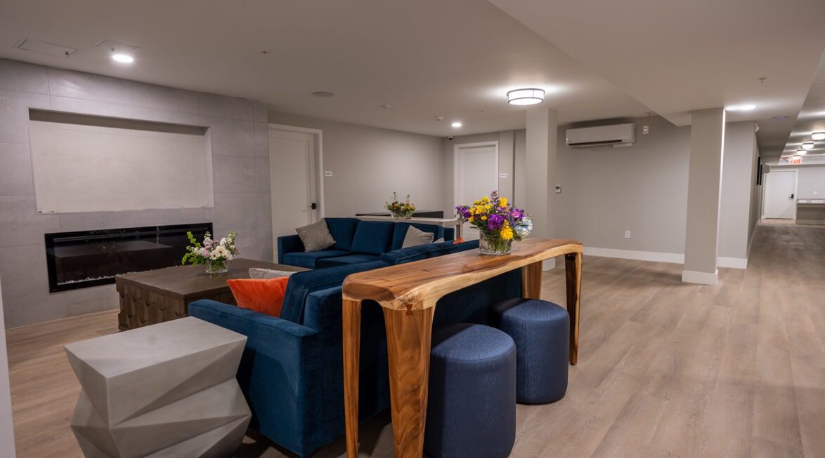 Comfortable resident lounge with fireplace, modern seating, and gathering space