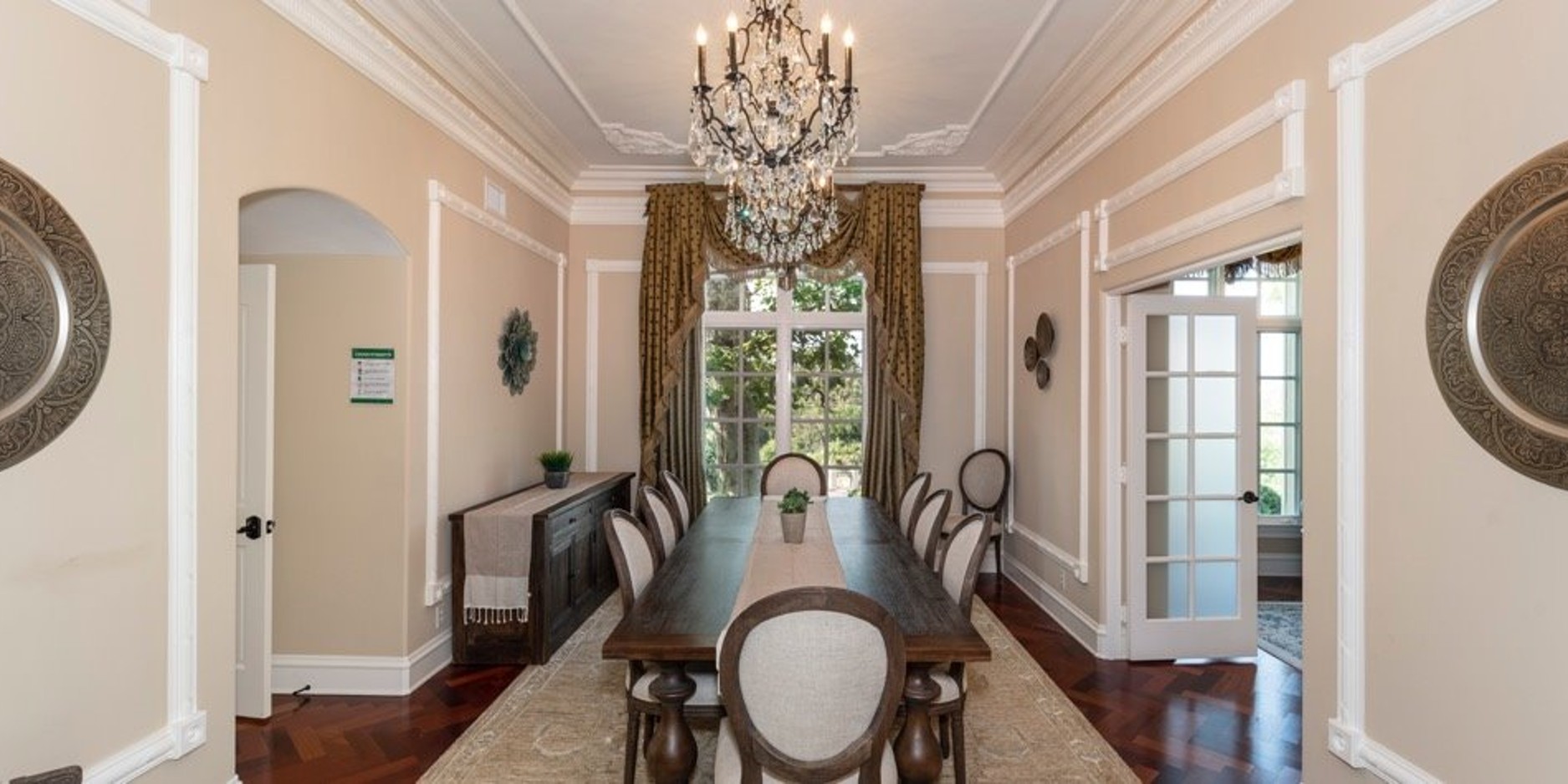 Formal dining room with long table and chandelier