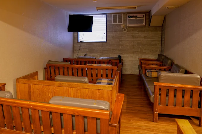 Lounge room with couches and wall-mounted TV