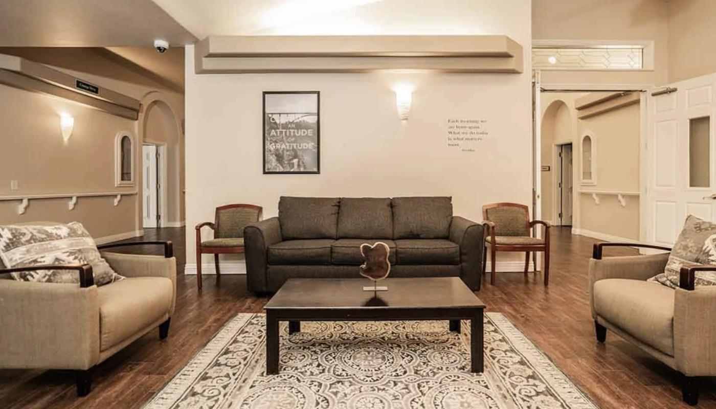 Sitting area with couches, rug, and motivational art