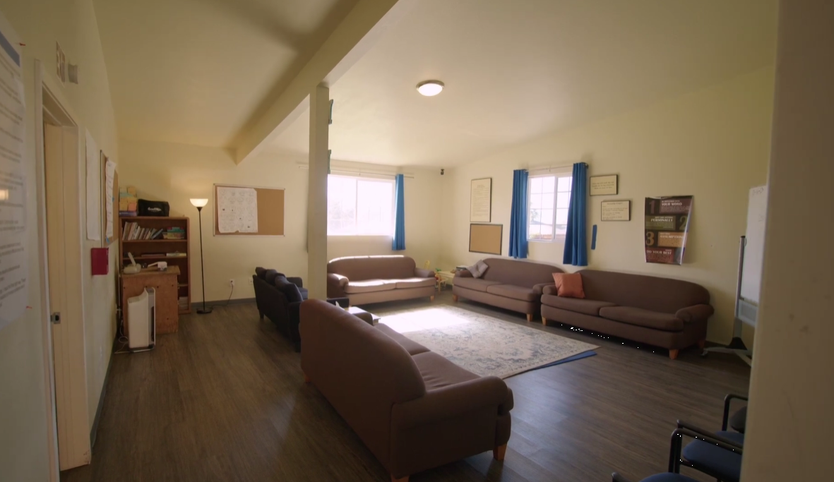 Room with brown sofas arranged for group meetings and discussion
