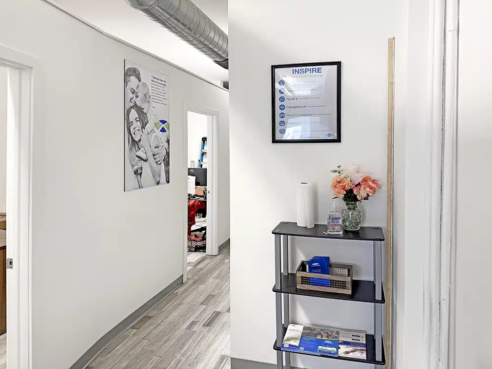 Hallway with shelves, sanitizer, and wall posters