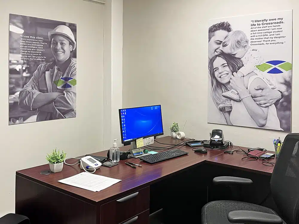 Office desk with computer and motivational posters