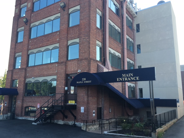 Exterior with a blue awning over main entrance.
