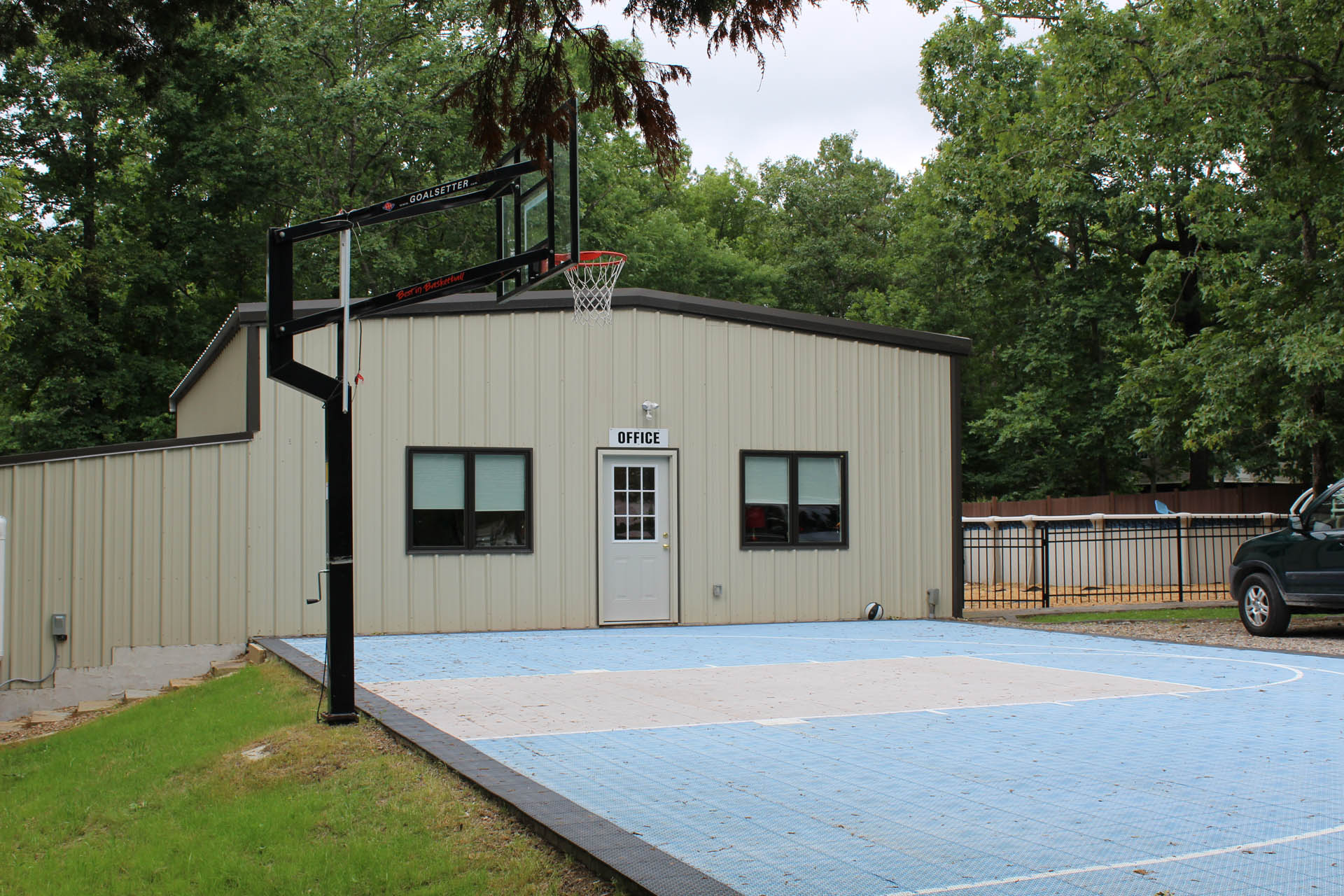 Outdoor basketball court surrounded by trees on the SOZO campus