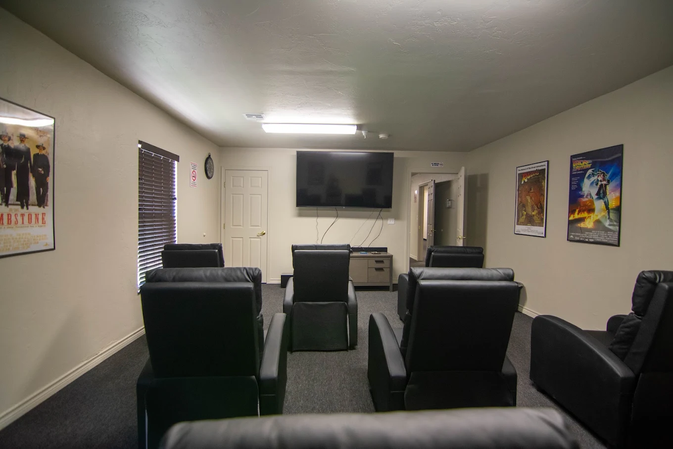 Media room with recliner chairs and large television