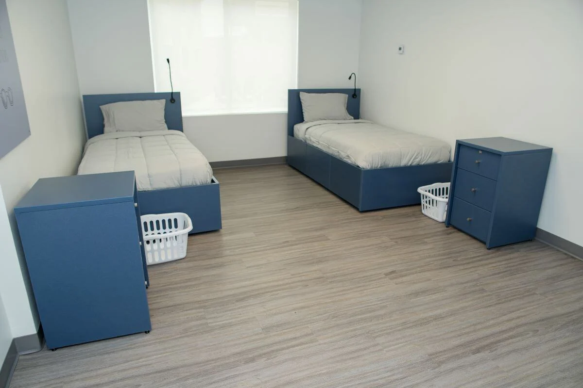 Bright room with two twin beds and storage drawers