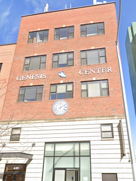 Brick Genesis Center building with clock and butterfly logo