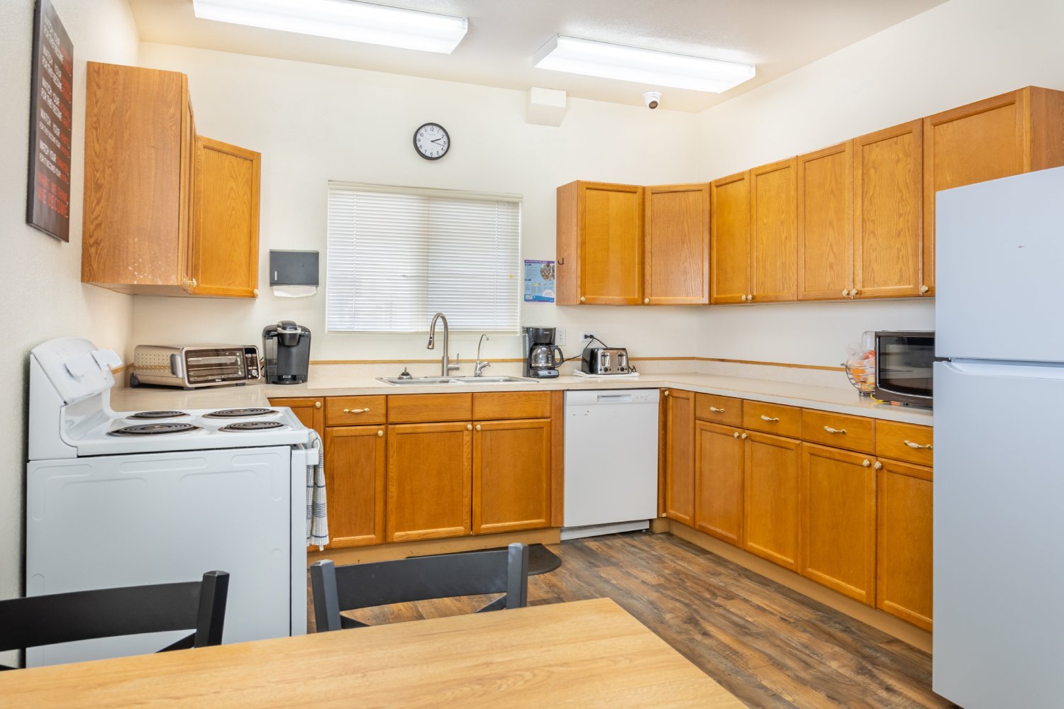 Kitchen with wooden cabinets, a stove, and appliances