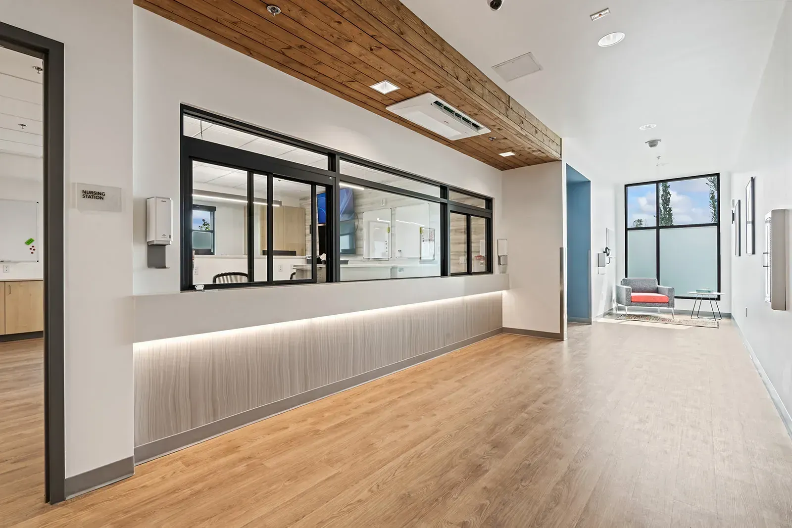 Modern nursing station with wood accents and open hallway