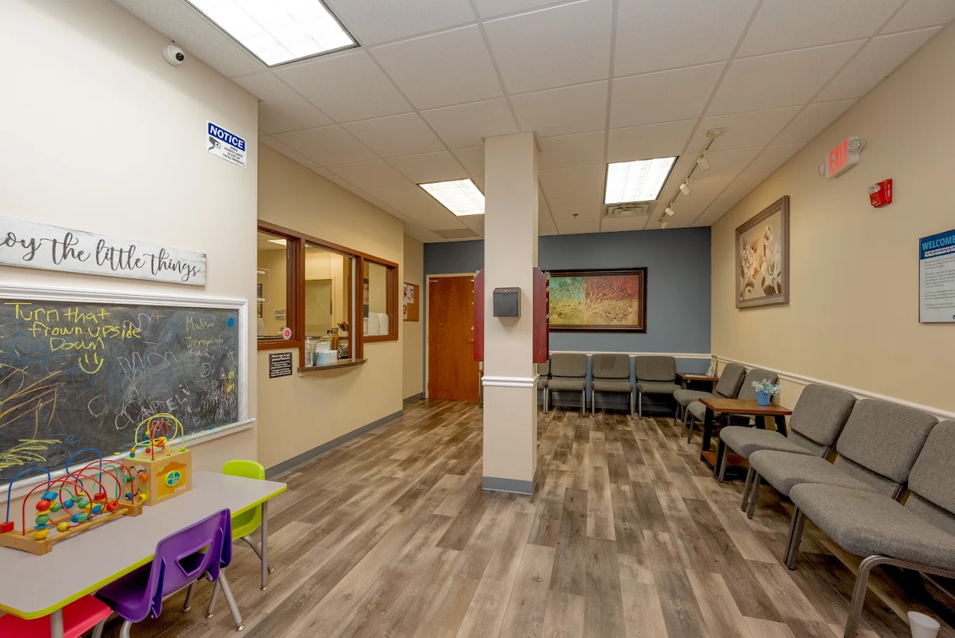 Waiting area with chairs and a children's activity space