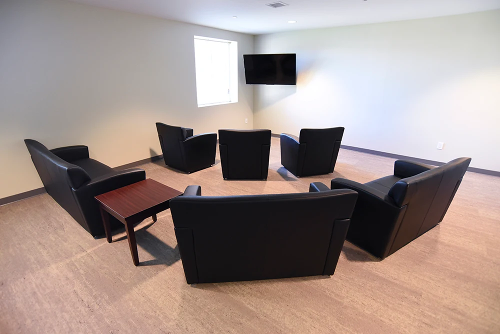 Armchairs facing a mounted television