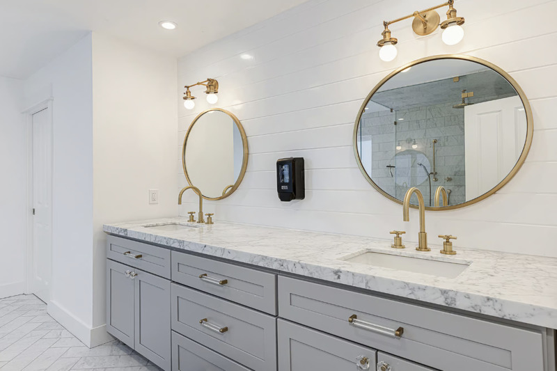 Elegant bathroom with double sinks and gold fixtures