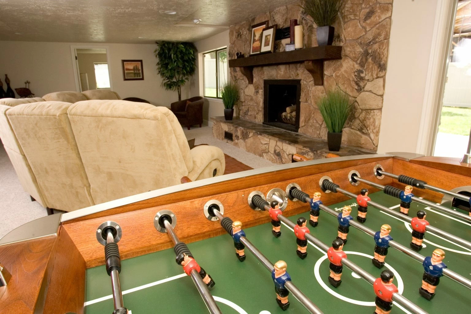 Foosball table in a recreation room with fireplace seating