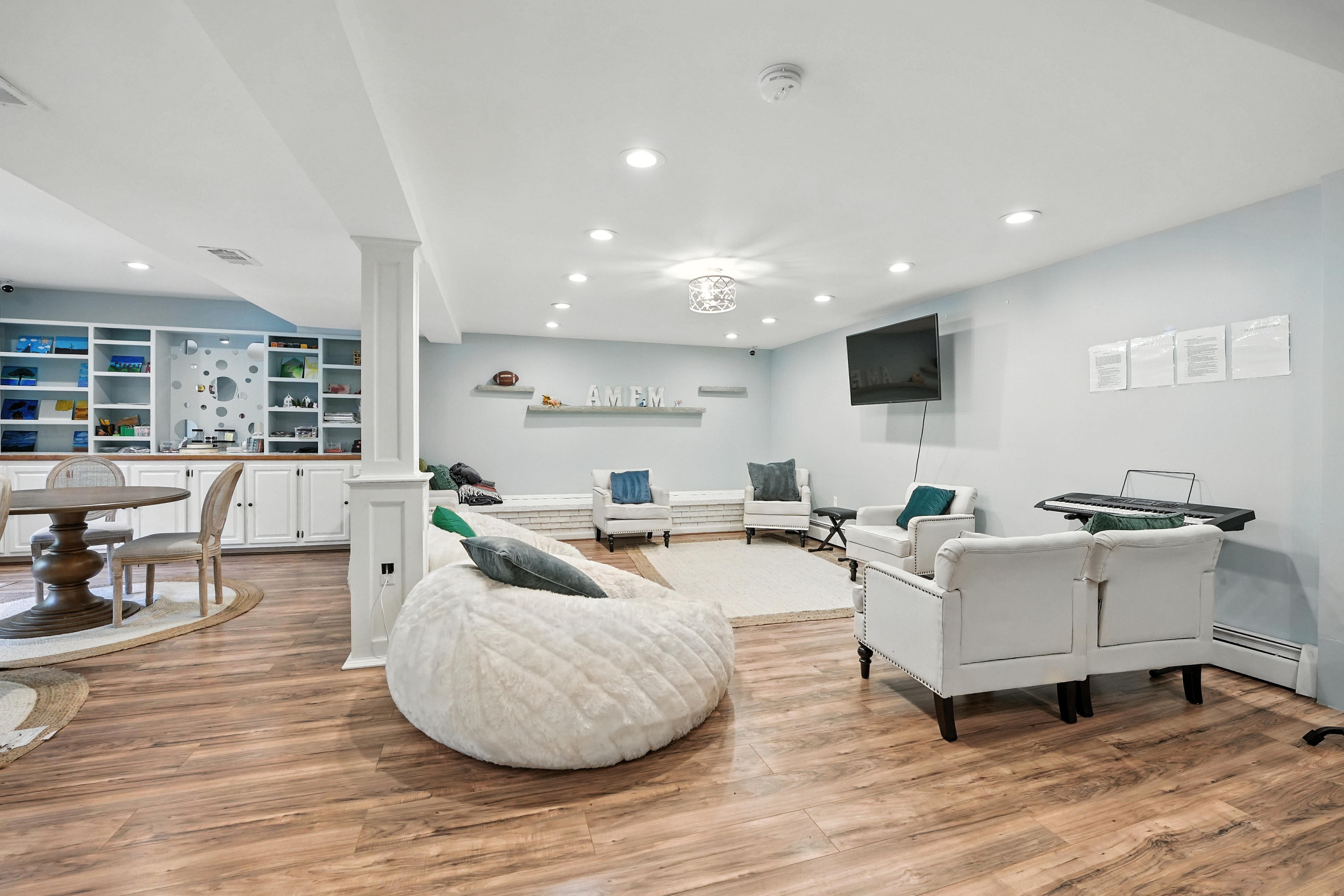 Bright lounge with chairs, beanbags, and wall shelving