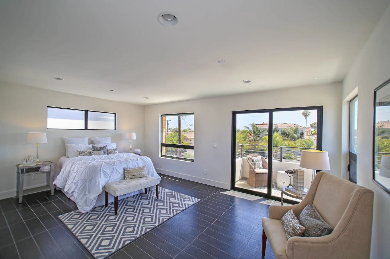 Spacious bedroom with balcony and large windows