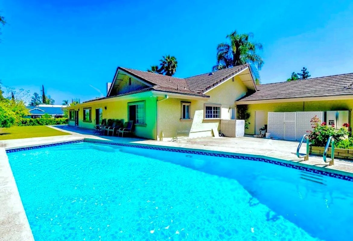 Outdoor swimming pool with patio seating at West Valley Detox