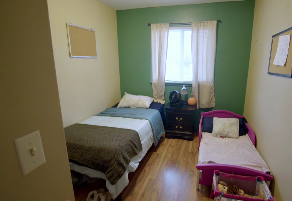 Bedroom with twin and toddler beds near a window