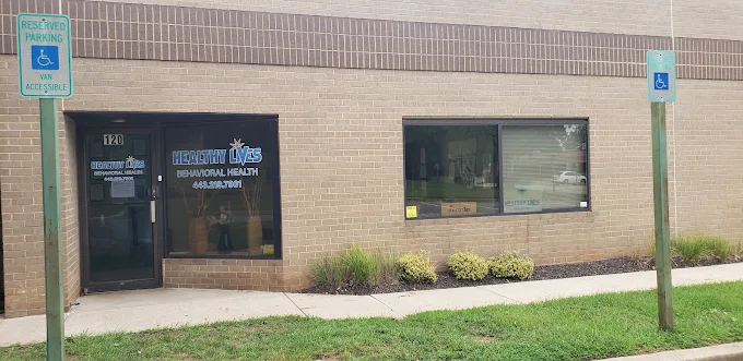 Exterior of Healthy Lives Behavioral Health with parking area.