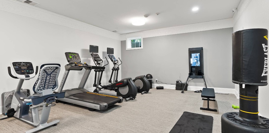 Fitness room with cardio machines and punching bag
