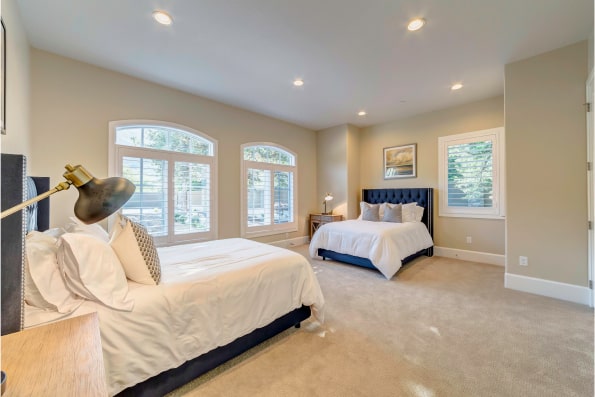 Spacious bedroom with two beds and large windows