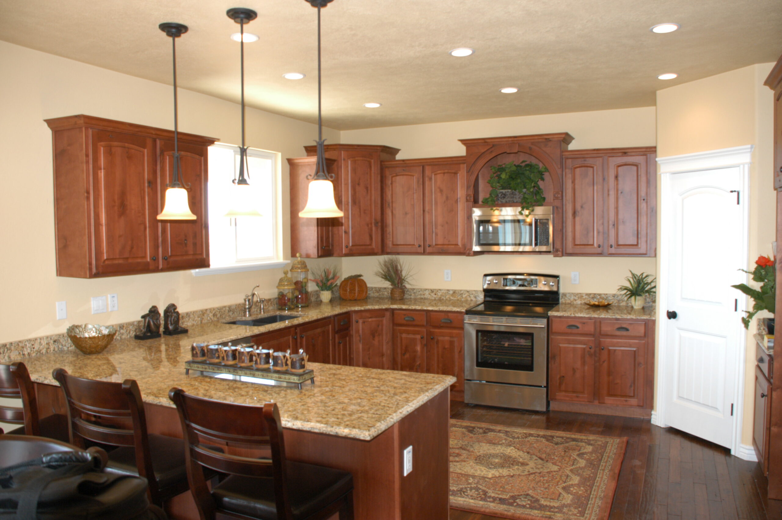 Residential kitchen with island seating and modern appliances