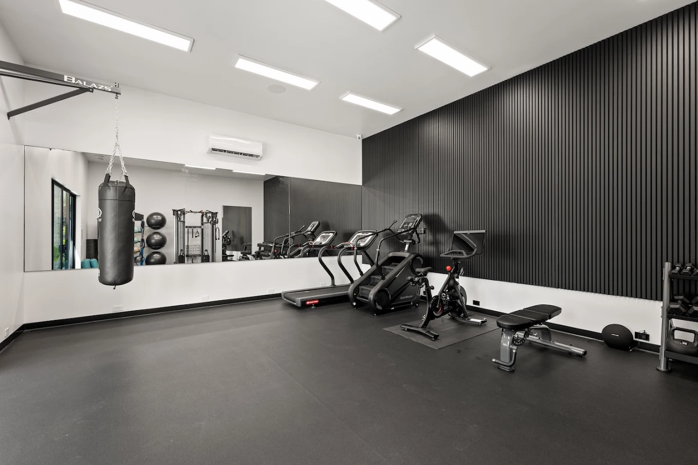 Gym with treadmills, punching bag, and exercise bikes