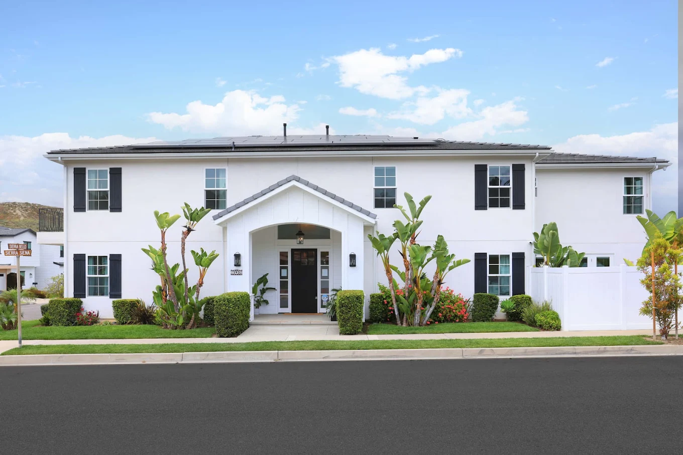 White two-story treatment facility with landscaped entrance