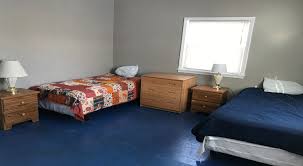 Shared bedroom with two beds and storage space
