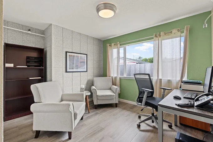 Office with desk, chairs, and window