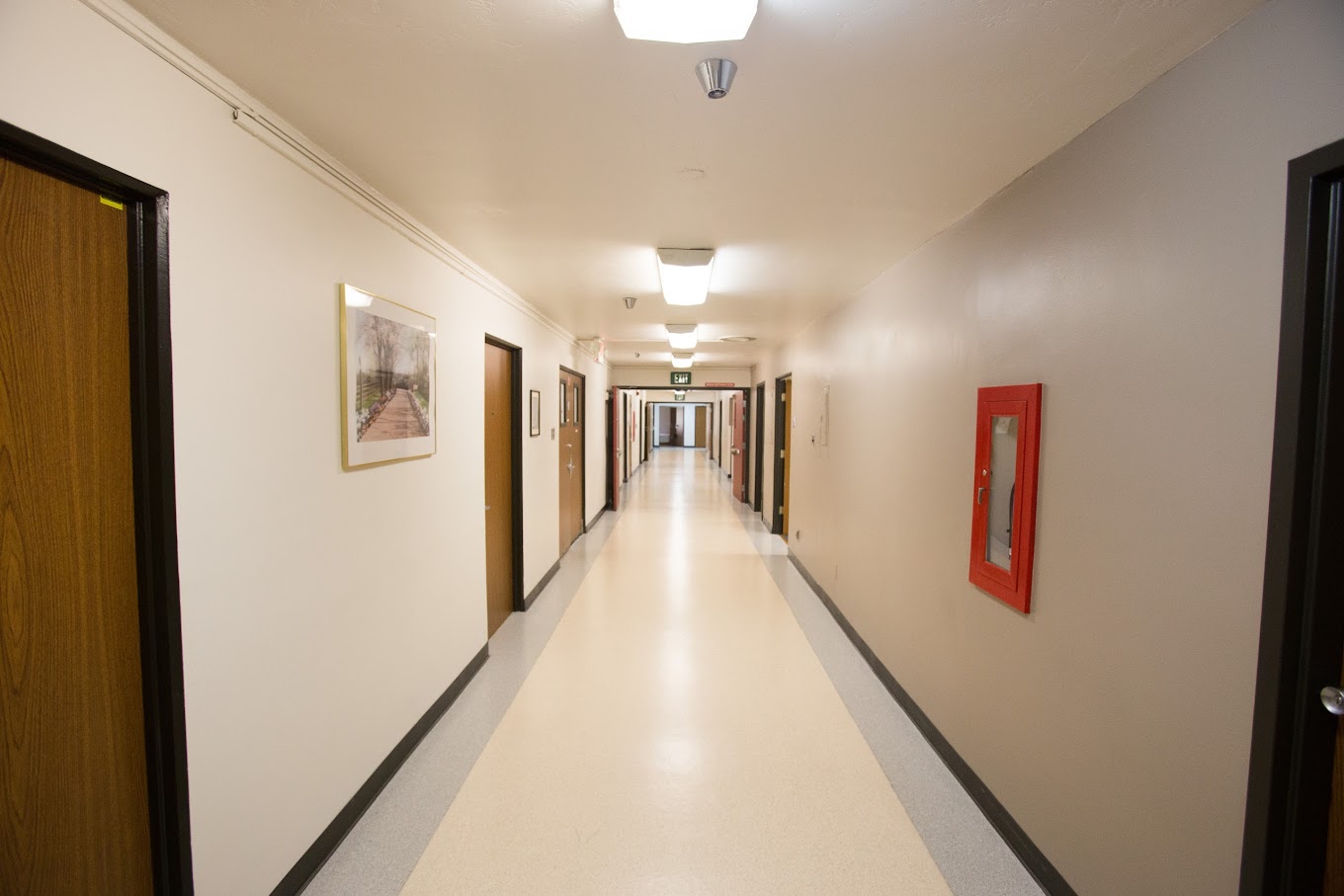 A clean, well-lit hallway with calming decor and easy access to various rooms, creating a safe and welcoming environment.