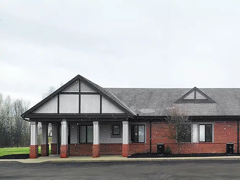 Rehab facility exterior with covered entrance and brick facade