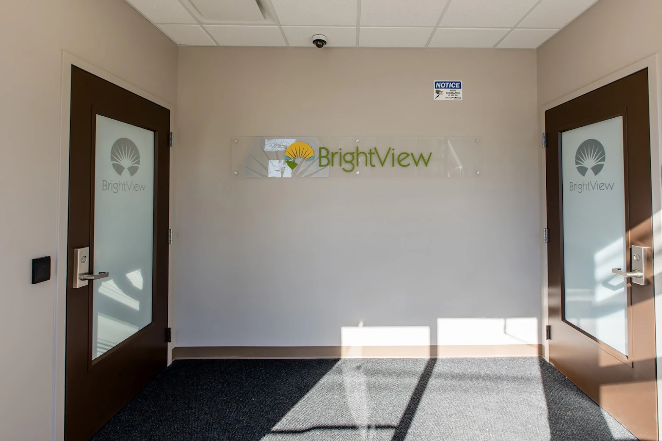 Entrance lobby with BrightView sign and two interior doors