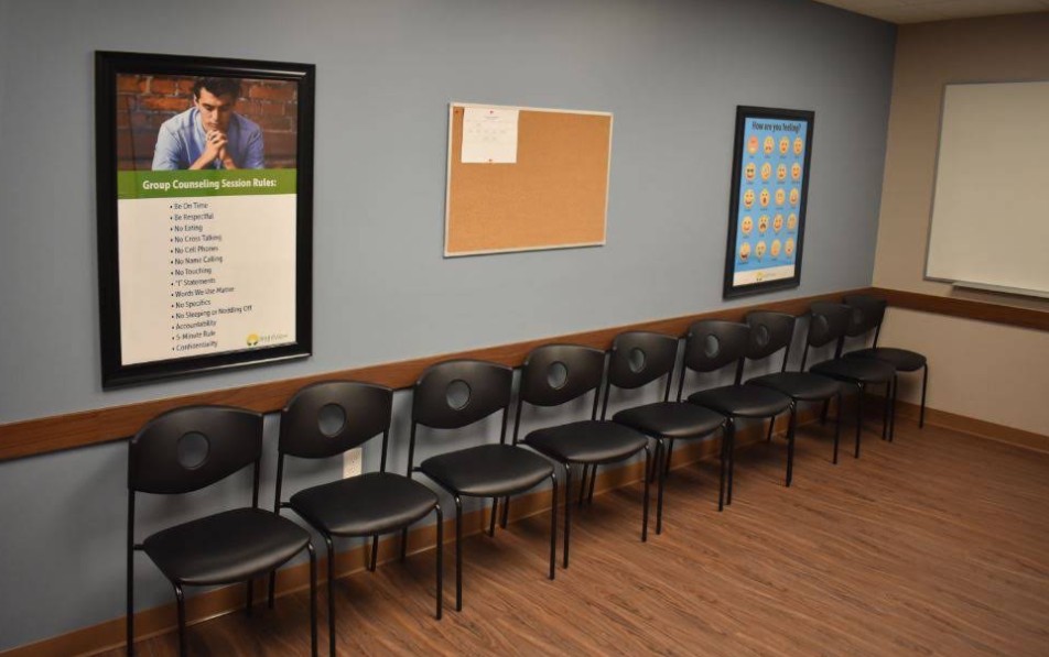 Group therapy room with chairs and whiteboard