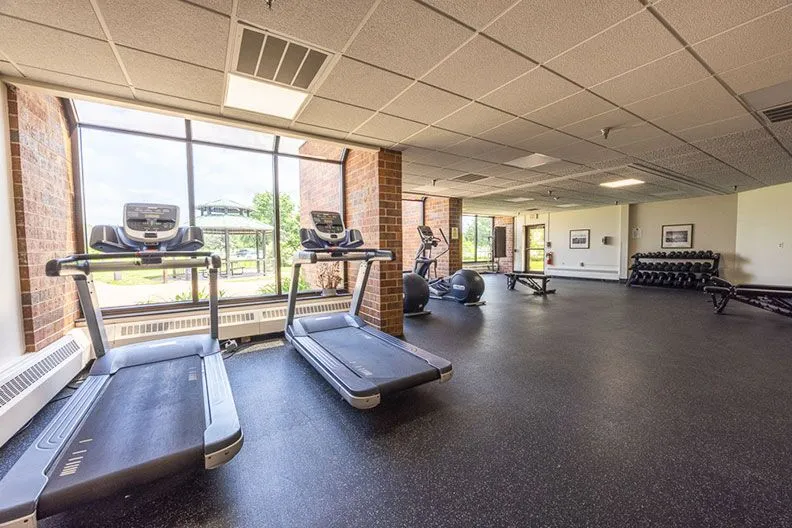 Fitness room with treadmills, weights, and exercise equipment
