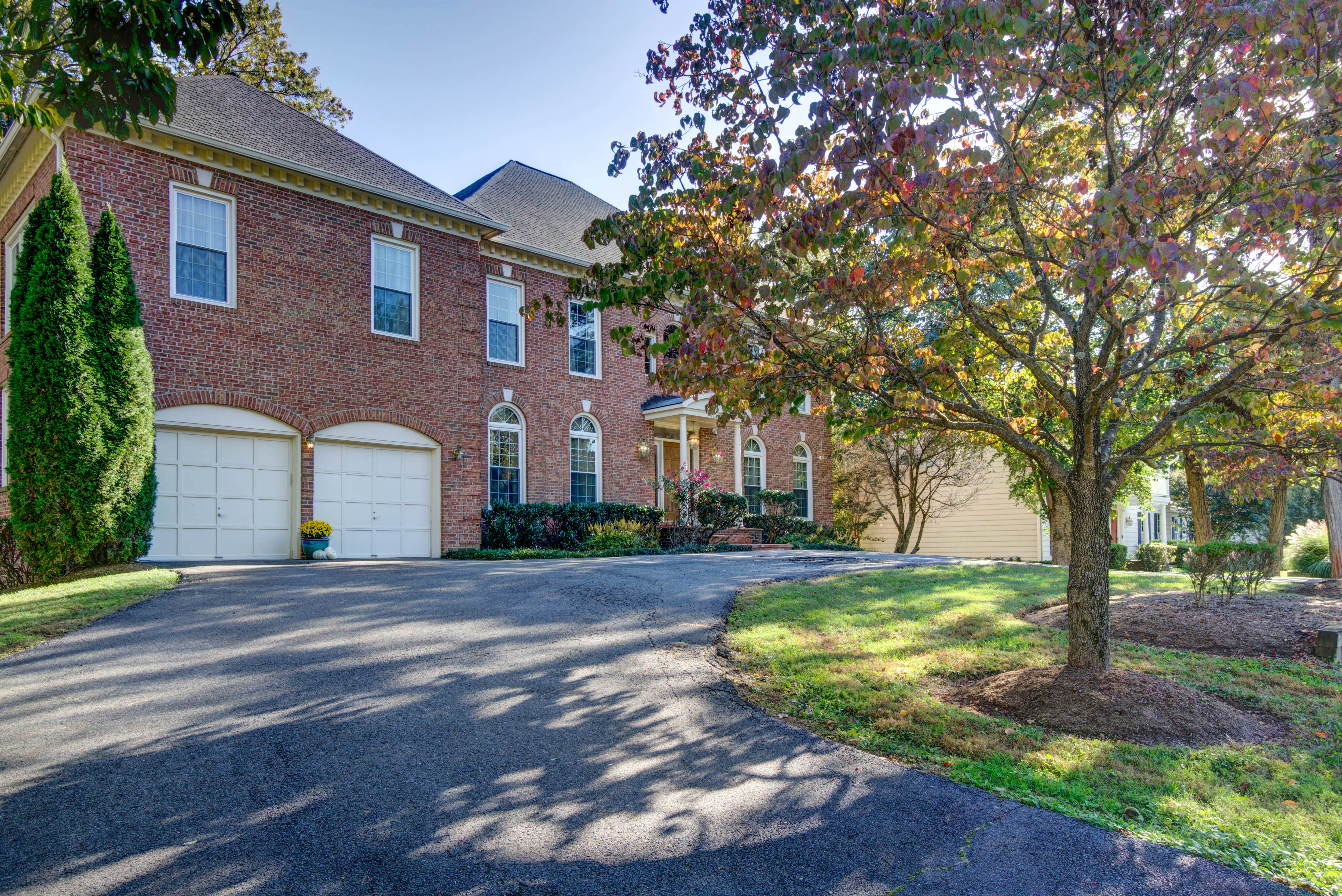 Brick exterior with driveway and columned entrance