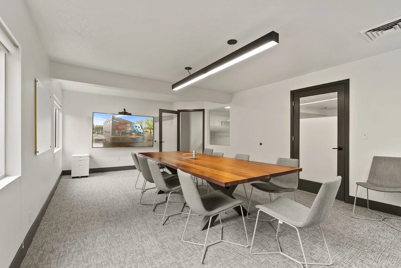 Conference room with large table and video display