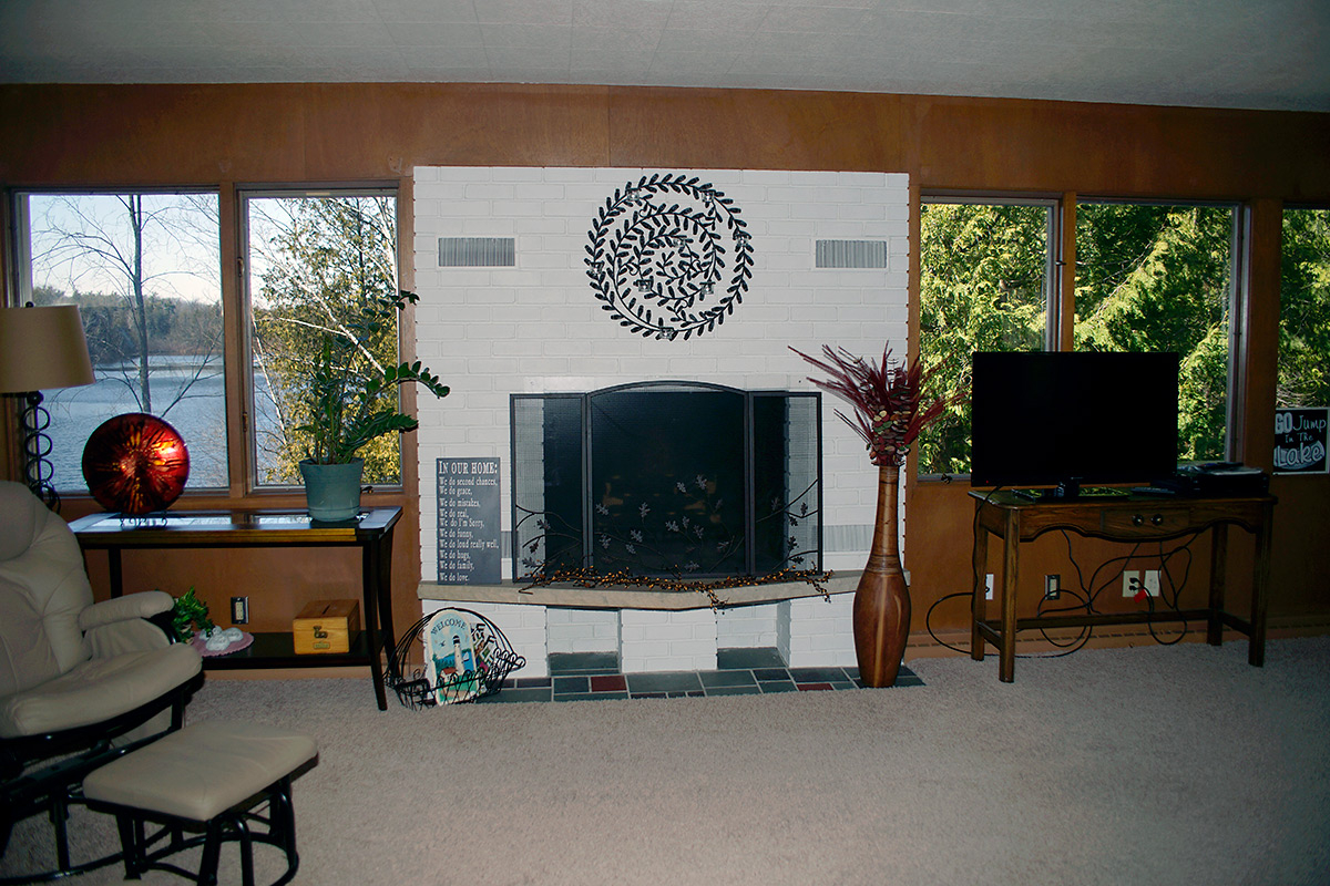 Comfortable living room with fireplace, seating, and large windows
